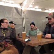 Four people sit at an outdoor patio at Fishers Brewing Company