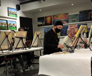 The Paint Mixer, a local art studio, leads participants through a wine and paint night called Fire Sun.